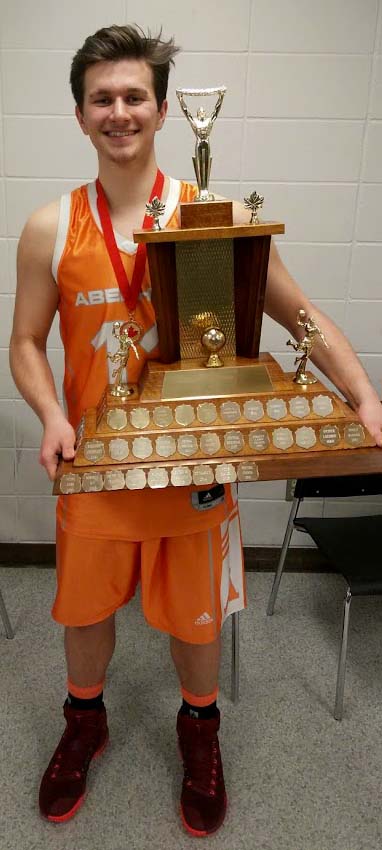 image des: Adrian holding a large trophy.